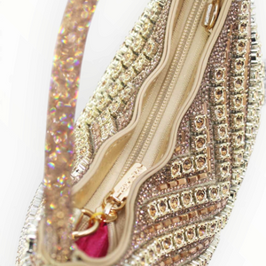 SUL EXTRAS Céleste evening bag featuring geometric rhinestone embellishments, a curved handle, and a zip closure.
