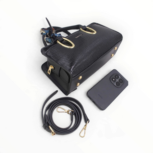 SUL EXTRAS Tom & Eva Amélie black croc-effect handbag with gold hardware, decorative scarf, and shoulder strap.