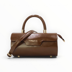 SUL EXTRAS brown patent-effect barrel handbag with gold-tone hardware, top handle, and detachable shoulder strap.
