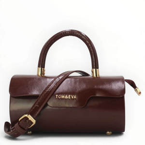 SUL EXTRAS Tom & Eva Colette barrel handbag in glossy dark brown synthetic leather with gold-tone hardware.