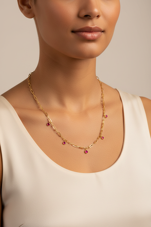 Gold chain necklace with pink gemstones on model