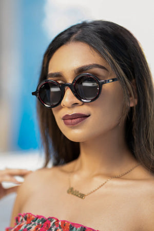 Sefsan Sphaira sunglasses with transparent red frame and smoke lenses, unisex modern design, lightweight and stylish for everyday wear model front view