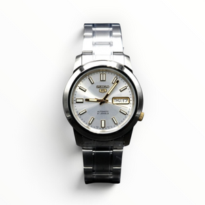 SUL EXTRAS Seiko 5 automatic watch with a silver dial, stainless steel band, and gold-tone accents