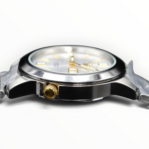 SUL EXTRAS silver and gold tone stainless steel analog watch with a white dial and side crown detail