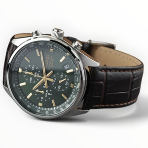 SUL EXTRAS Seiko chronograph watch with a green dial, gold-tone hands, and brown embossed leather strap.