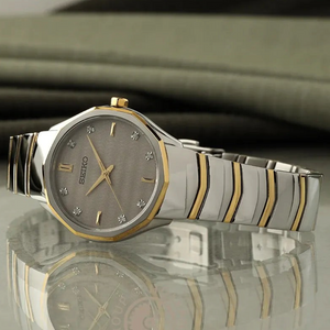 SUL EXTRAS Seiko Classic ladies' watch with a grey textured dial, diamond markers, and two-tone stainless steel band.