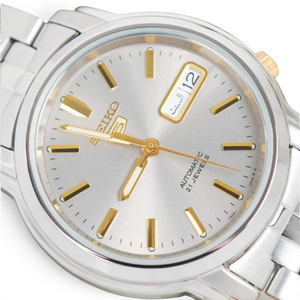 SUL EXTRAS Seiko 5 automatic watch featuring a grey dial, gold-tone hands, and silver-tone stainless steel bracelet.