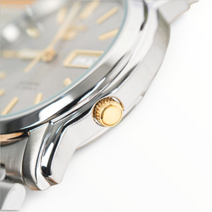 SUL EXTRAS Seiko 5 automatic watch featuring a silver stainless steel case, grey dial, and gold-tone crown detail.