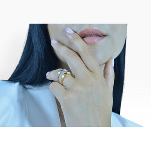 SUL EXTRAS gold plated sterling silver ring with pearl and red zirconia stone worn on a woman's hand