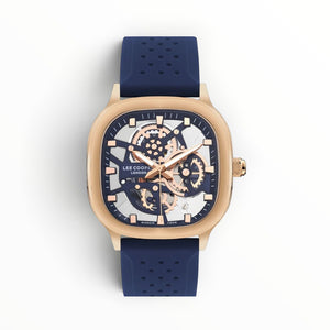 SUL EXTRAS Lee Cooper London cushion-square watch with rose gold case, skeleton dial, and navy blue perforated strap.