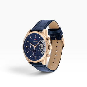 SUL EXTRAS Tommy Hilfiger men's watch with navy blue crocodile-embossed leather strap and rose gold open-heart dial.