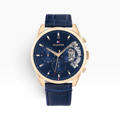SUL EXTRAS Tommy Hilfiger men's watch with navy blue dial, open-heart movement, and rose gold case on leather strap.
