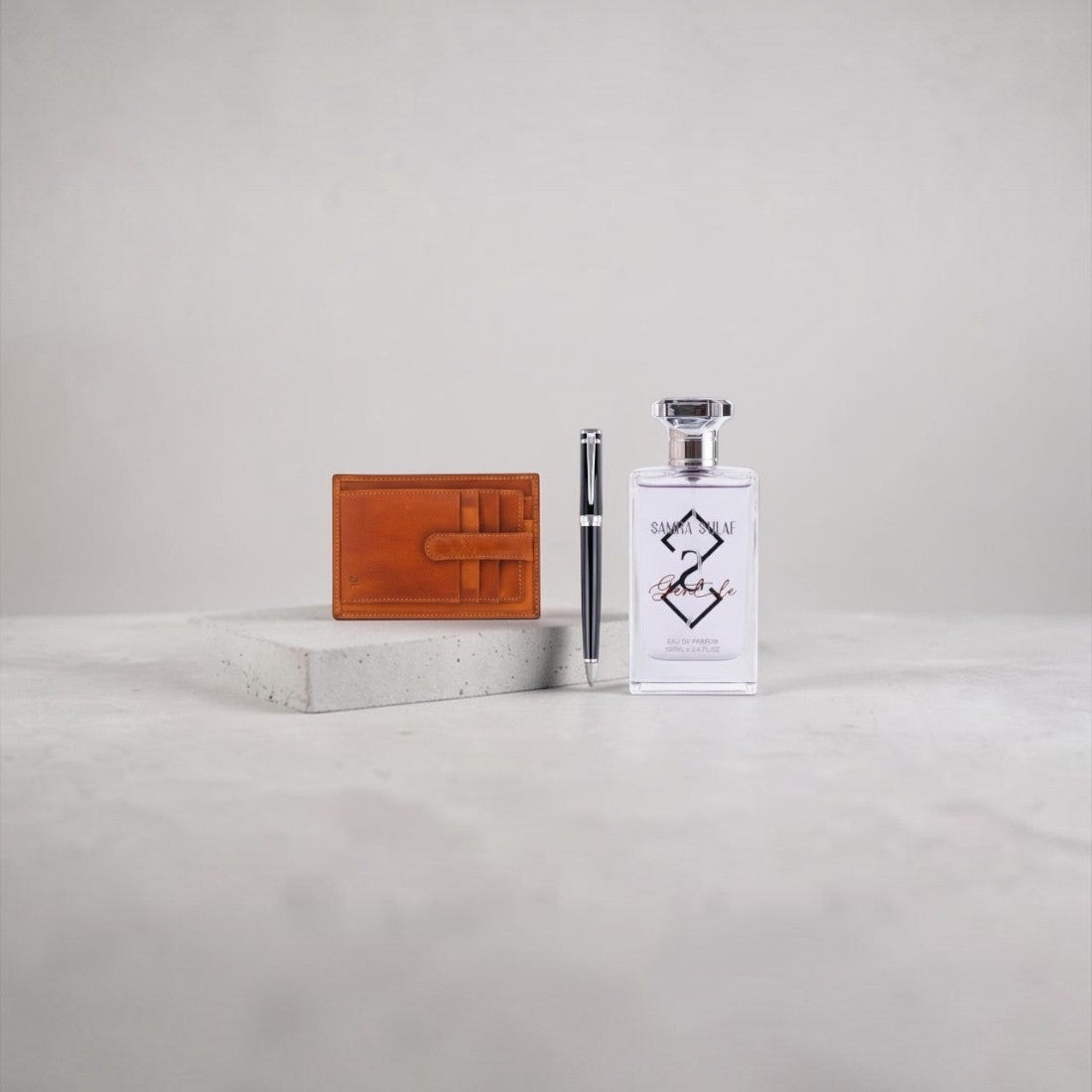 SUL EXTRAS Vanguard executive gift set featuring a tan leather card holder, a sleek pen, and a bottle of Gentle perfume