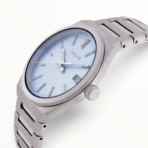 SUL EXTRAS Seiko Classic men's watch with a light blue textured dial, silver stainless steel case, and bracelet.