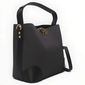 SUL EXTRAS Margot black bucket bag with grained texture, gold-tone emblem, and short shoulder handle.