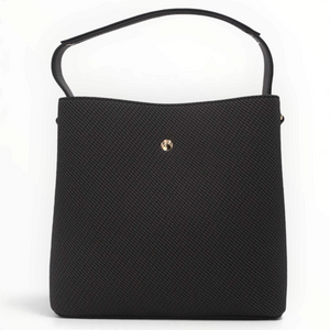 SUL EXTRAS black Margot bucket bag with grained texture, gold-tone emblem, and shoulder handle on white background
