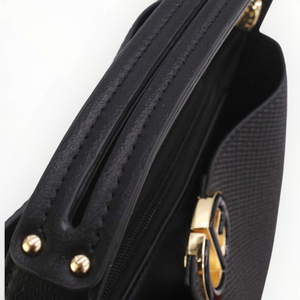 SUL EXTRAS Margot bucket bag in black grained synthetic leather with gold-tone hardware and cut-out handle detail.