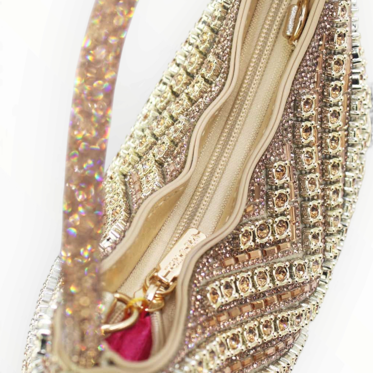 SUL EXTRAS Céleste evening bag featuring geometric rhinestone embellishments, a curved handle, and a zip closure.