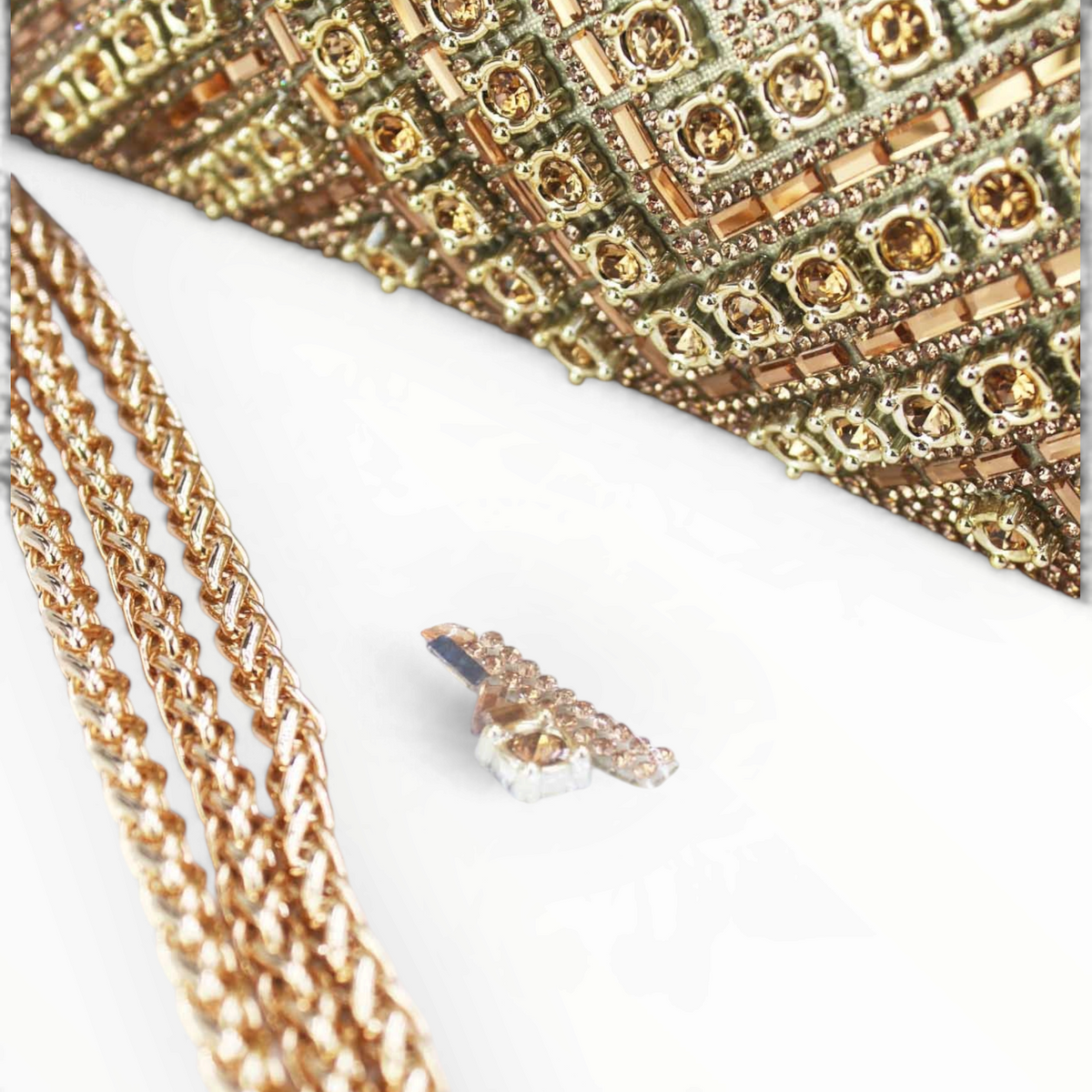 SUL EXTRAS Céleste evening bag featuring intricate geometric gold rhinestone embellishments and a gold chain strap.