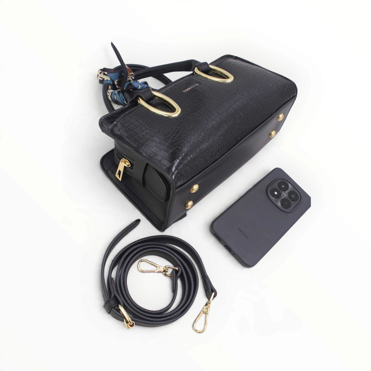 SUL EXTRAS Tom & Eva Amélie black croc-effect handbag with gold hardware, decorative scarf, and shoulder strap.