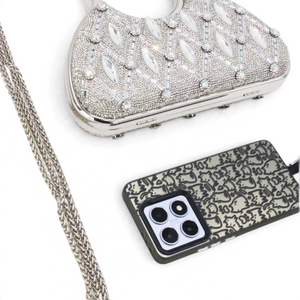 SUL EXTRAS Aurelia evening bag with rhinestone latticework, circular handles, and a detachable silver chain strap.