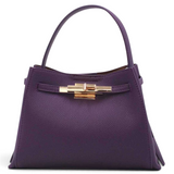 SUL EXTRAS Adèle shoulder bag in purple grained synthetic leather with gold-tone hardware and a structured silhouette.