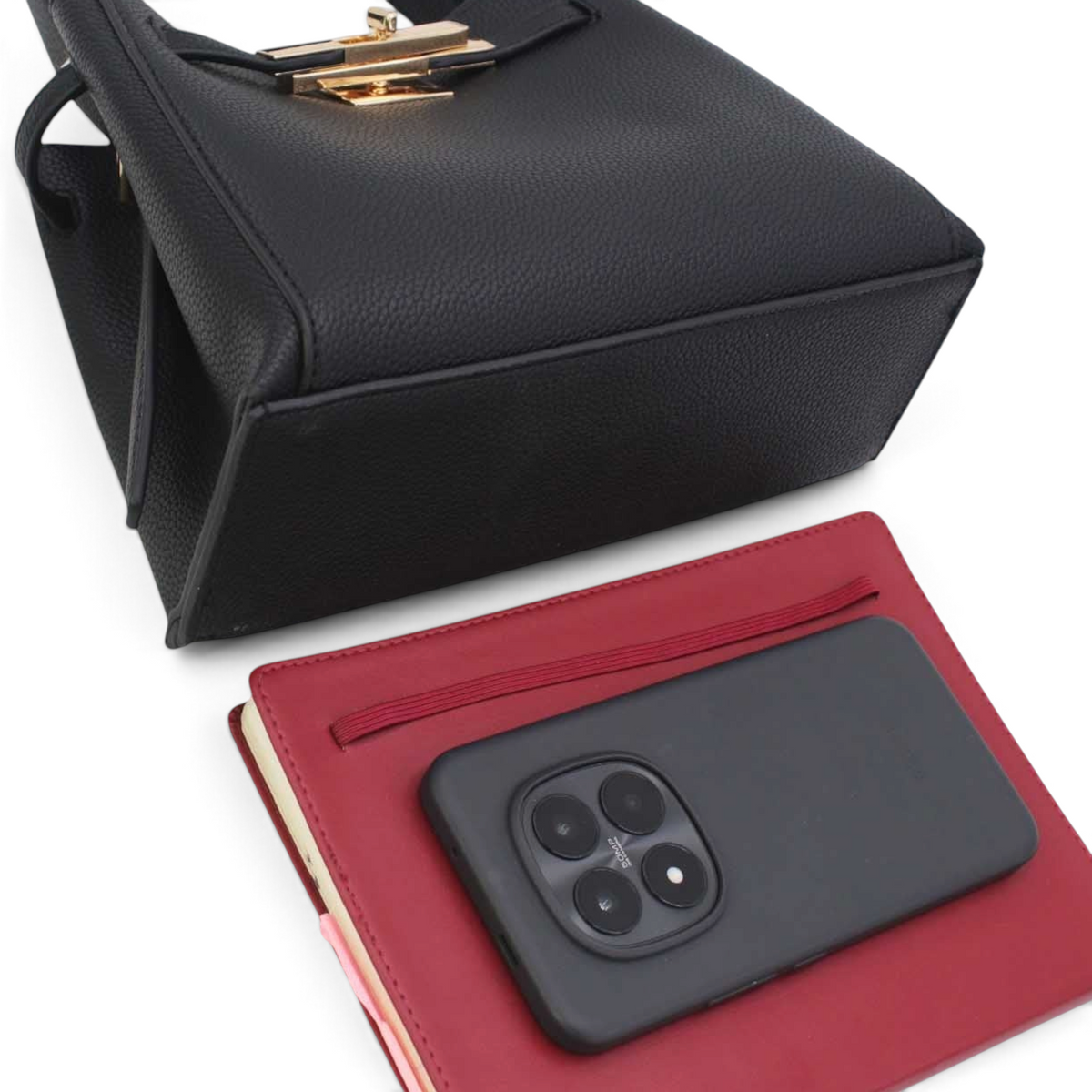 SUL EXTRAS Adèle black grained synthetic shoulder bag with gold-tone hardware and removable pouch on a desk