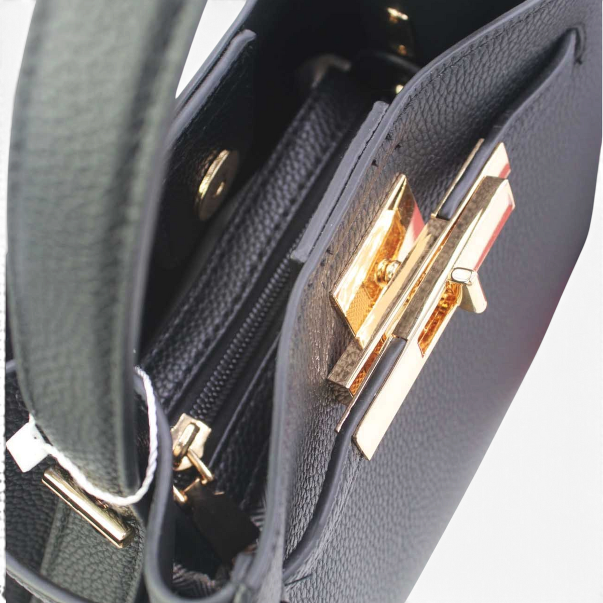 SUL EXTRAS Adèle black grained synthetic shoulder bag with gold-tone hardware and a structured trapeze silhouette.