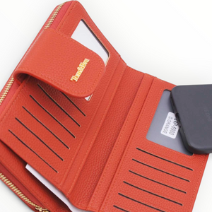 SUL EXTRAS Tom & Eva orange pebbled leather-effect wallet with gold-tone hardware, card slots, and an ID window.
