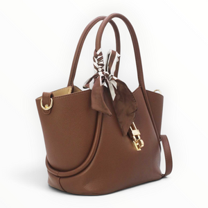 SUL EXTRAS Vivienne brown grained synthetic trapeze handbag with gold hardware, top handles, and a decorative scarf.