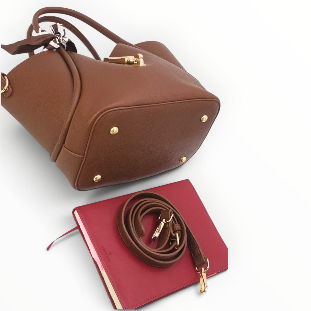 SUL EXTRAS Vivienne trapeze handbag in brown grained synthetic leather with gold hardware, scarf, and shoulder strap.