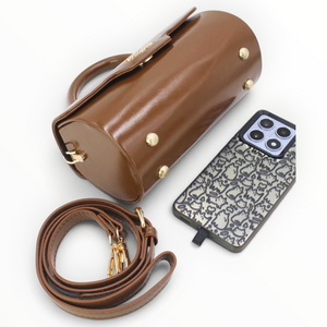 SUL EXTRAS Tom & Eva brown patent barrel handbag with gold hardware, detachable strap, and metal base feet