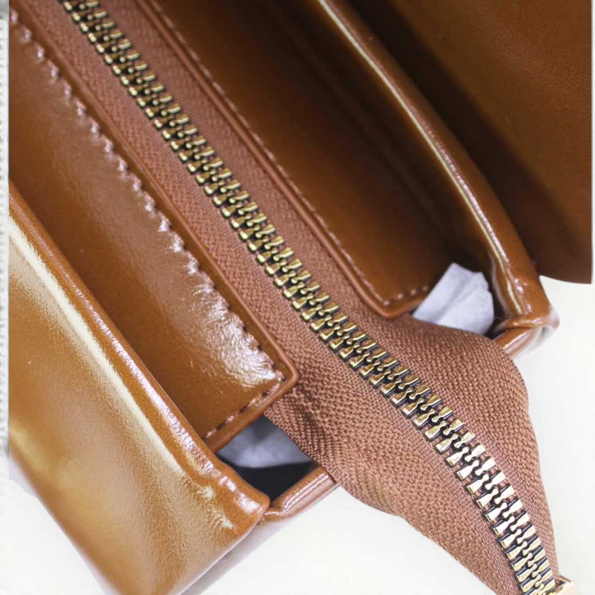 SUL EXTRAS Tom & Eva Colette handbag interior showing brown synthetic material with a gold-tone zipper closure