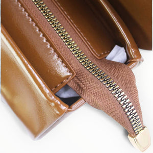 SUL EXTRAS Tom & Eva Clarisse handbag interior view showing brown synthetic material with gold-tone zipper closure