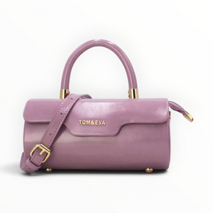SUL EXTRAS Tom & Eva purple patent barrel handbag with gold hardware, top handle, and adjustable shoulder strap.