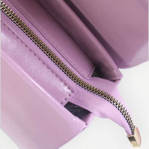 SUL EXTRAS Tom & Eva Clarisse handbag interior view showing the purple patent-effect lining and gold-tone zip closure