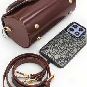SUL EXTRAS Tom & Eva Colette brown barrel handbag with gold hardware, detachable strap, and protective metal base feet.