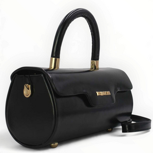 SUL EXTRAS Tom & Eva Colette black barrel handbag with glossy patent finish, gold-tone hardware, and top handle.