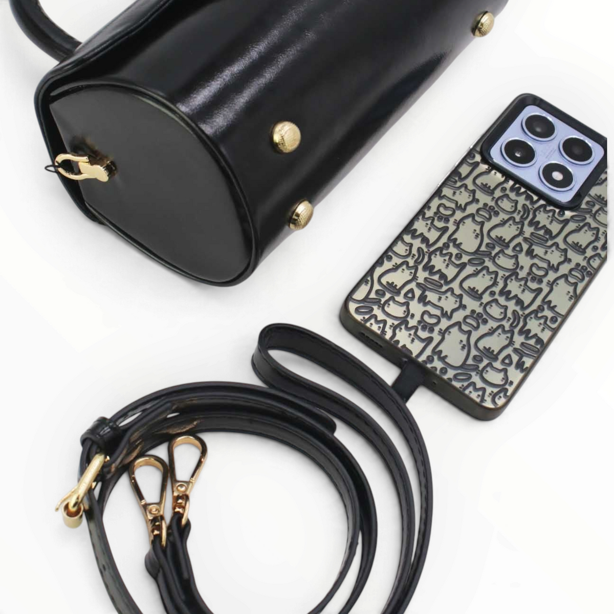 SUL EXTRAS Tom & Eva Colette black barrel handbag with gold hardware, detachable strap, and matching phone case