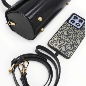 SUL EXTRAS Tom & Eva Colette black barrel handbag with gold hardware, detachable strap, and matching phone case