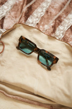 Load image into Gallery viewer, Unisex Sefsan Evolution sunglasses featuring durable brown tortoise frame, UV-protected transparent blue lens, and contemporary design for men and women front view 
