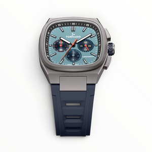 SUL EXTRAS Tornado Aristocrate chronograph watch with gunmetal cushion case, ice blue dial, and navy rubber strap.