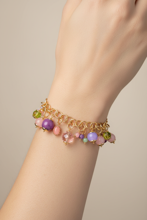 Colorful gemstone charm bracelet on model's wrist