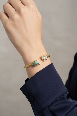 Gold mesh butterfly cuff bracelet on model's wrist