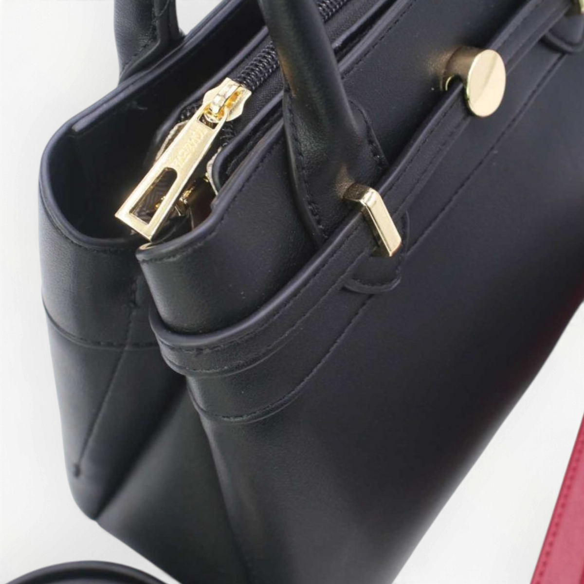 SUL EXTRAS Tom & Eva black structured handbag with gold-tone hardware, twin handles, and decorative belt detail.