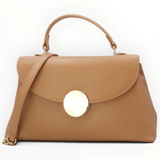 SUL EXTRAS Tom & Eva tan minimalist handbag with a structured silhouette, top handle, and gold-tone circular accent.