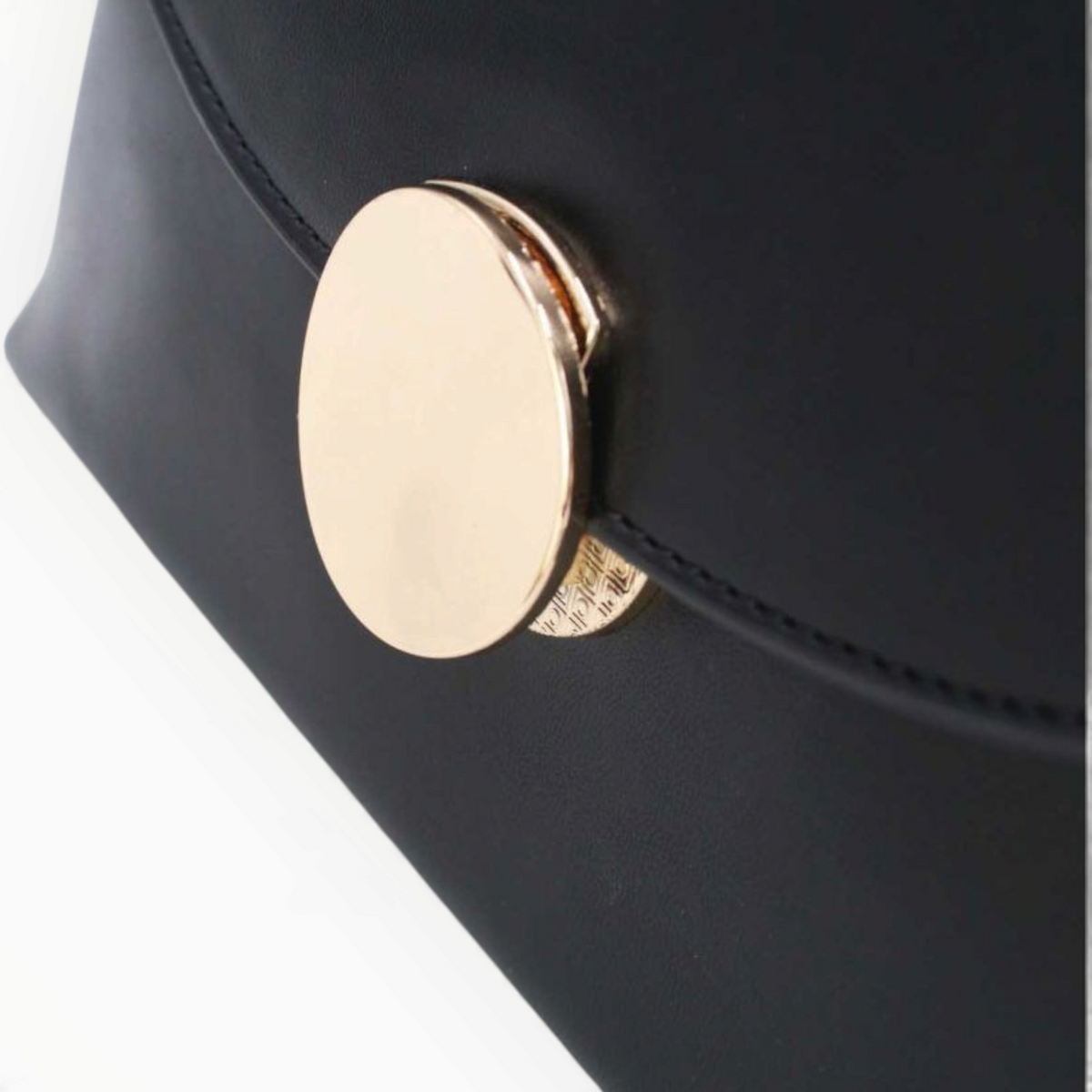 SUL EXTRAS Tom & Eva black minimalist handbag featuring a smooth synthetic finish and a circular gold-tone accent.