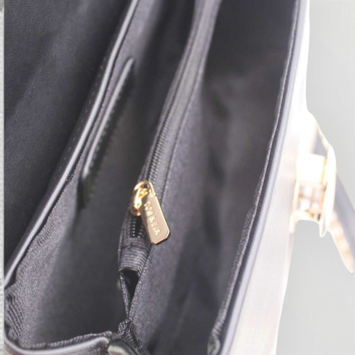 SUL EXTRAS Tom & Eva black synthetic handbag interior with two compartments, polyester lining, and gold zipper detail