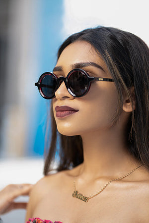 Unisex Sefsan Sphaira sunglasses featuring transparent red full-rim frame, smoke-tinted lenses, and contemporary casual style model side view 