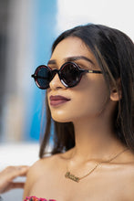 Load image into Gallery viewer, Unisex Sefsan Sphaira sunglasses featuring transparent red full-rim frame, smoke-tinted lenses, and contemporary casual style model side view 
